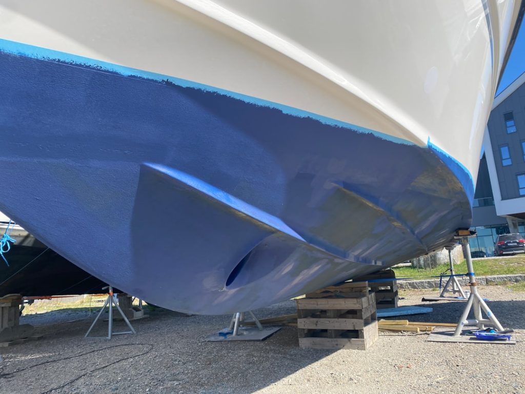 a-blue-and-white-boat-being-worked-on-49nbgjybfq0